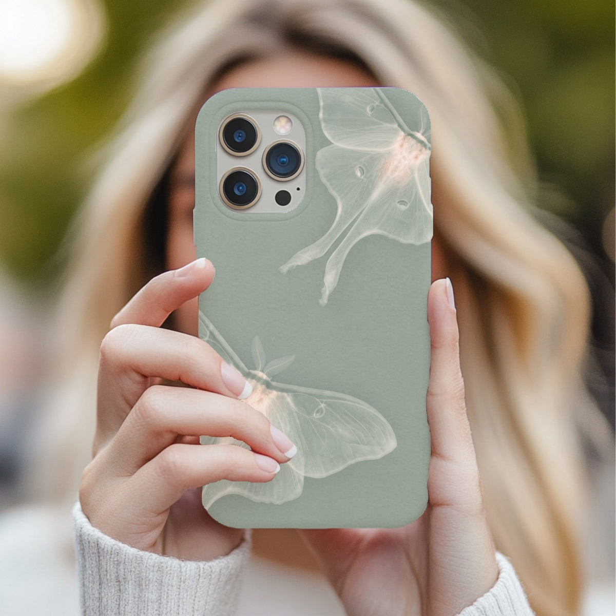 Sage Luna Moth tough phone case held up in a mirror selfie