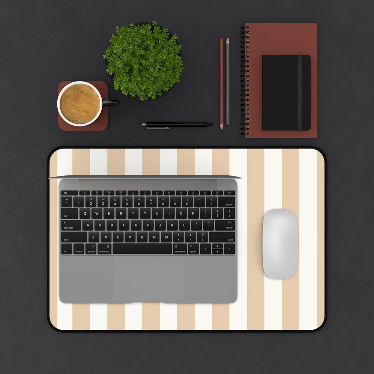 Sand cabana stripe desk mat on a dark desk with a laptop and mouse