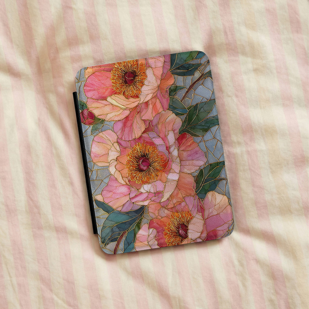 Stained Glass Peony Kindle case lying on pink striped bedding