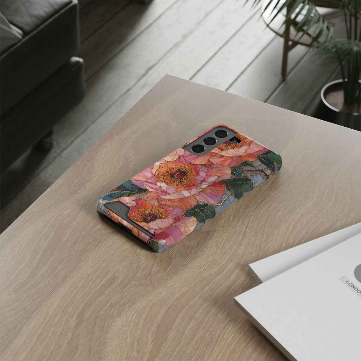 Stained Glass Peony card holder phone case lying on a wooden desk
