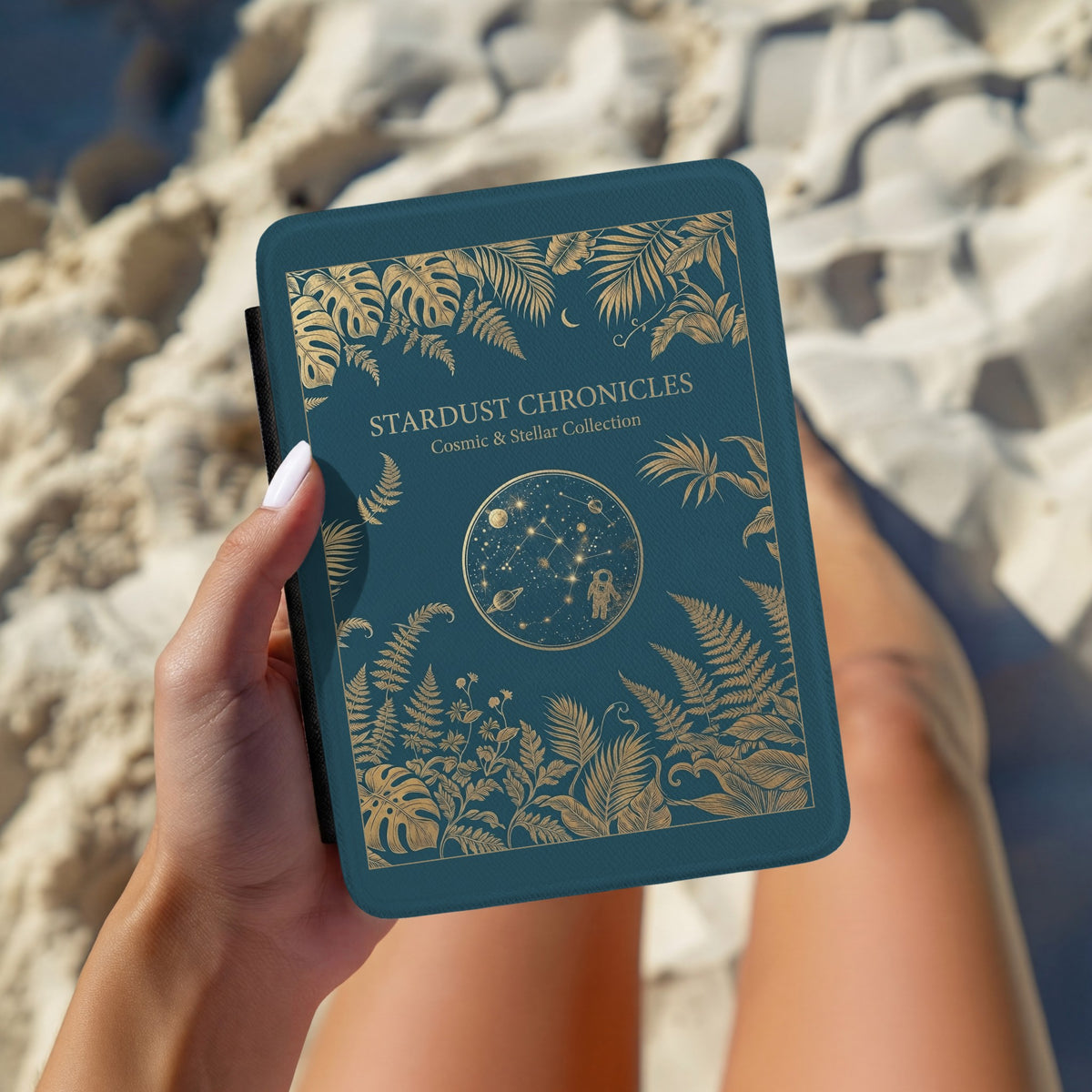 Stardust Chronicles Kindle case held in hand over striped bedding