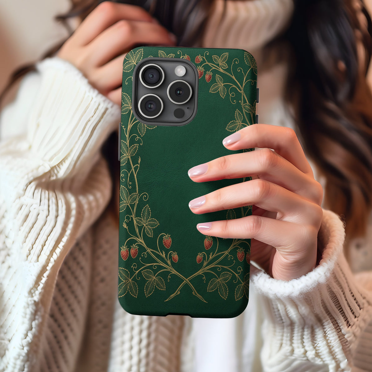 Strawberry Vine tough phone case held in hand with cream sweater