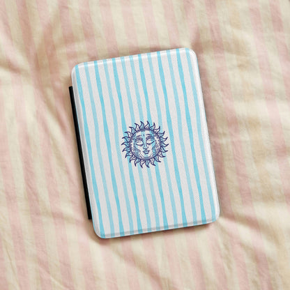 Sunny Striped Blue Kindle case resting on striped bedding