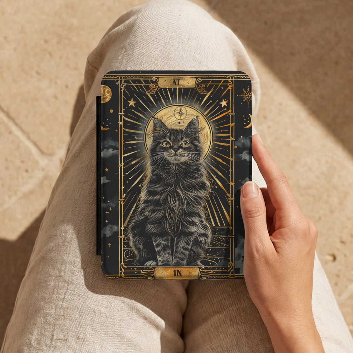 Tarot Cat Kindle case held on a lap while reading