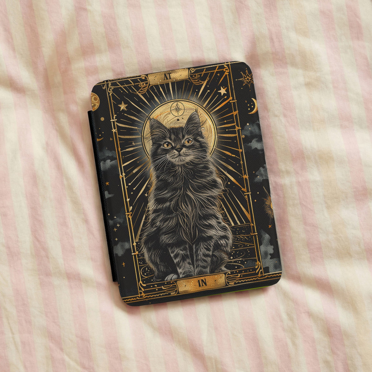 Tarot Cat Kindle case on pink striped linen bedding