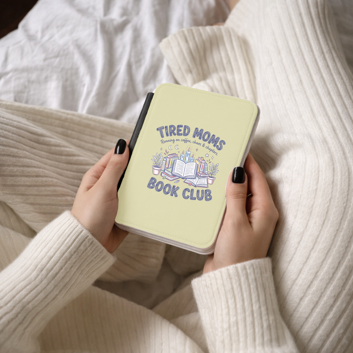 Tired Moms Book Club Kindle case held while reading in a knit sweater