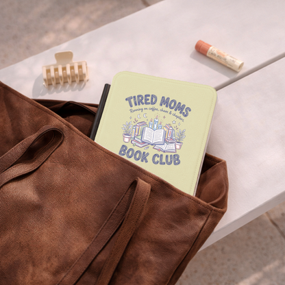 Tired Moms Book Club Kindle case tucked in a brown leather tote bag
