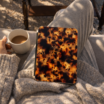 Tortoiseshell Kindle case lifestyle photo, warm amber and espresso tones