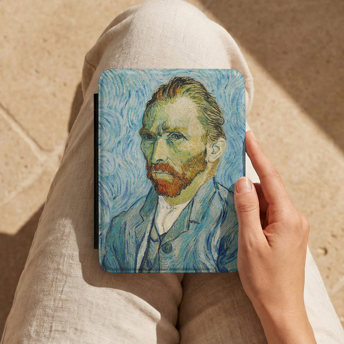 Van Gogh Portrait Kindle case held on a lap while reading