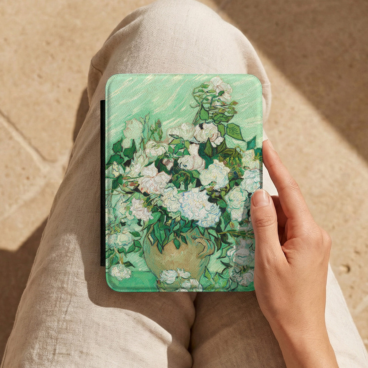 Van Gogh Roses Kindle case held on a lap while reading