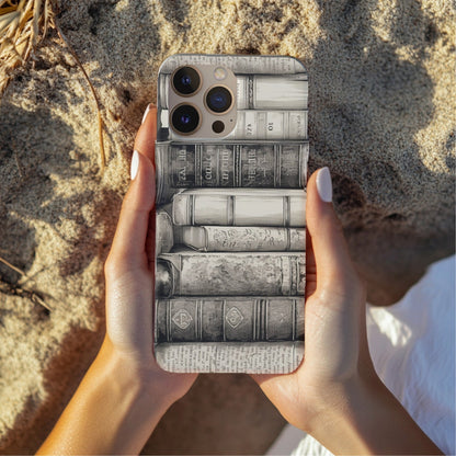 Hands holding the Vintage Books phone case outdoors