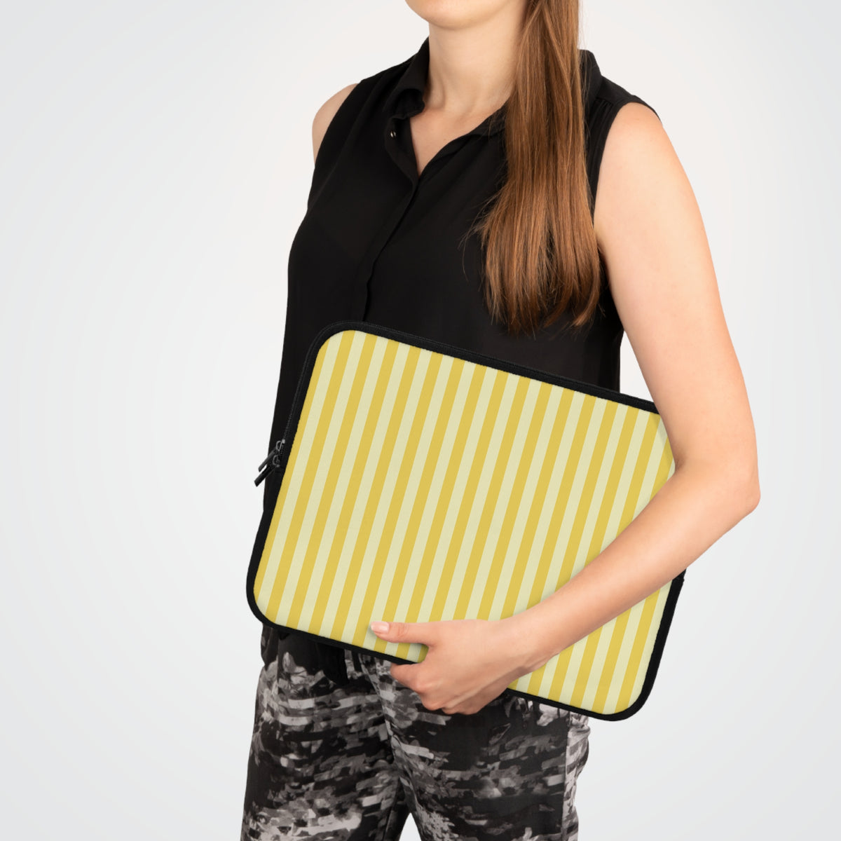 Woman carrying a Yellow Cabana Stripe laptop sleeve